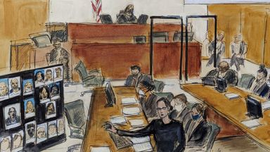 In this illustration drawn from a video feed, Assistant US Attorney Elizabeth Geddes, bottom, presents her closing statement to the jury (not seen in video feed) while pointing to a large panel of photos of R. Kelly's inner circle and employees, Wednesday, Sept. 22, 2021, in New York. R. Kelly is seen seated at the defense table in inset on upper left. He is also seated far right at the bottom on the image. (AP Photo/Elizabeth Williams) 